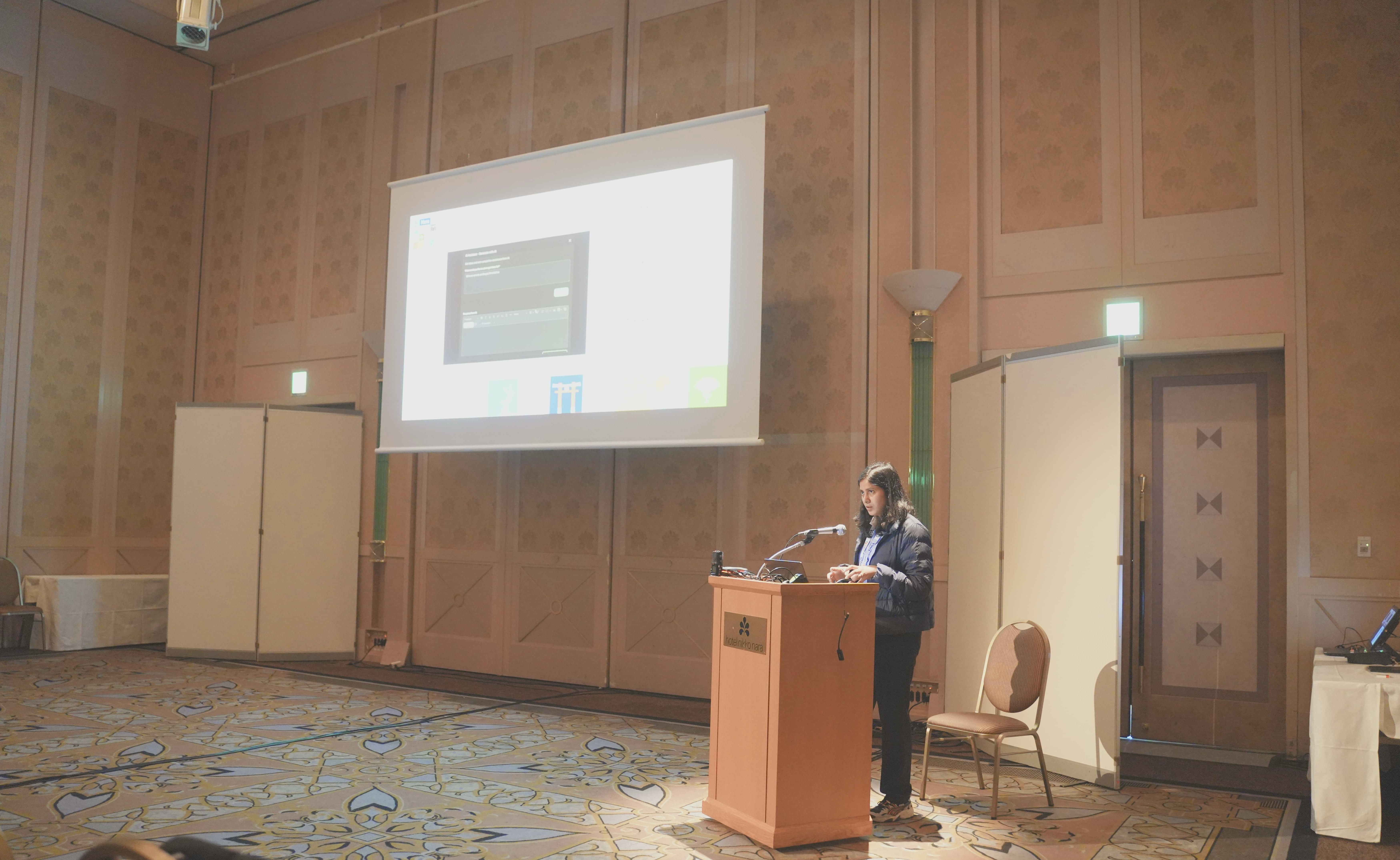 Picture of Akansha presenting at DrupalCon, side view